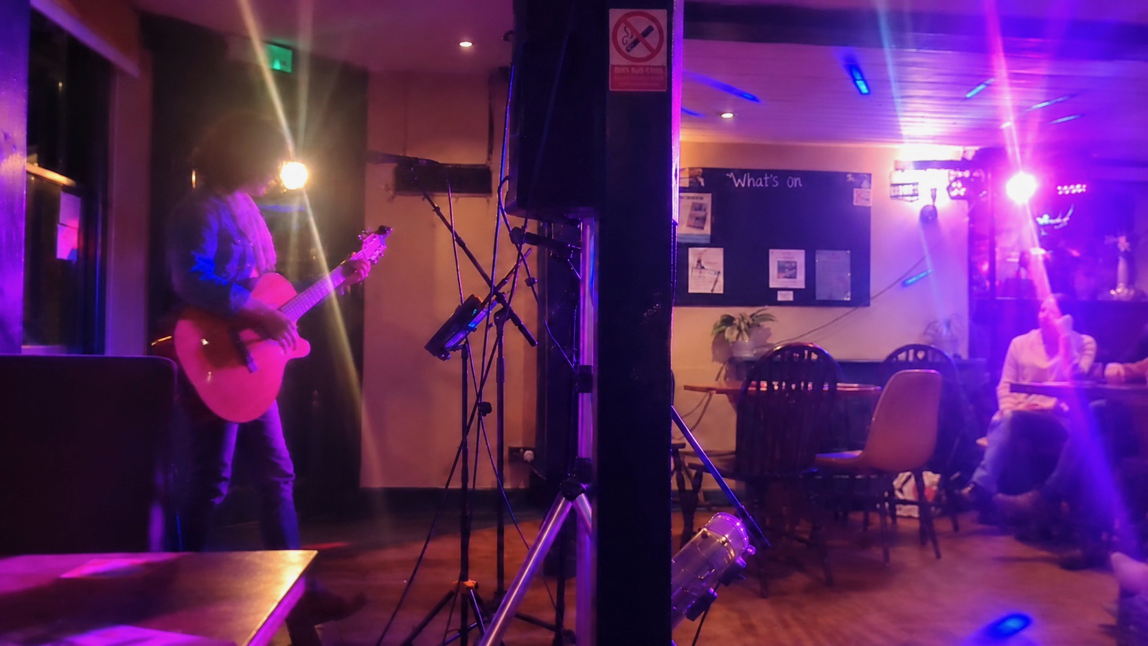 Annie Alice playing acoustic guitar at The Cock Tavern in Ongar